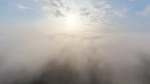 Golden sun breaks through misty clouds above calm water Video stock 339861026