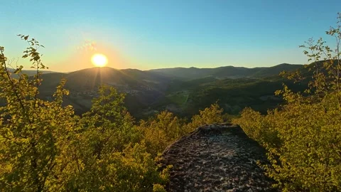 Golden sun climbs over distant hills. Boracki krs Serbia 動画素材 345005654