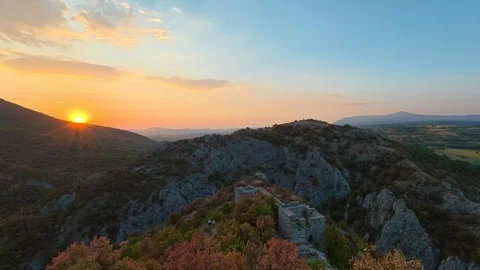 Golden sun dips behind rocky hilltops. Soko Grad, Serbia 動画素材 345897252