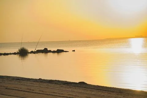 Golden sun dips low, casting warm glow Stock Photos