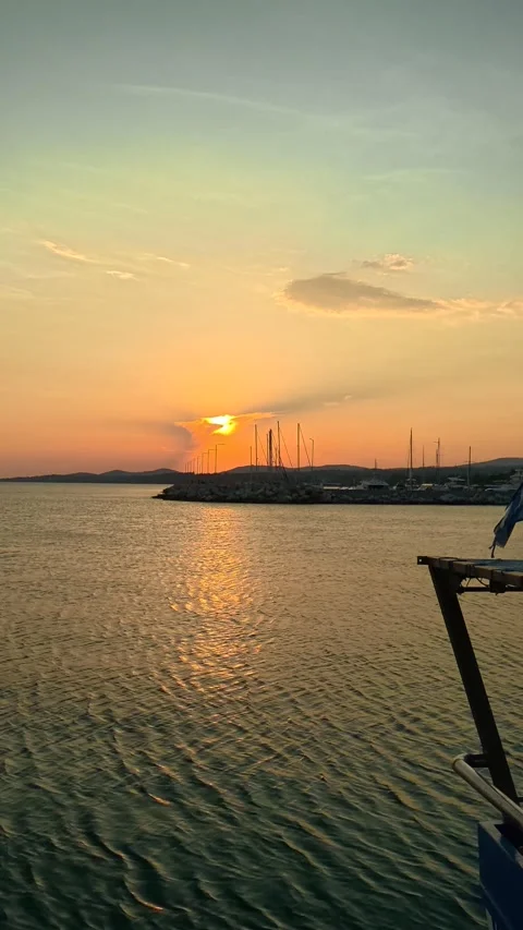 Golden sun dips low over calm waters. Nikiti, Greece. Vertical Video stock 338357671