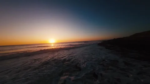 Golden sun dips low over ocean waves Stock Footage 339789155