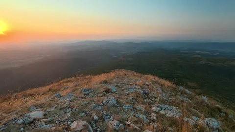 Golden sun dips over rugged mountain peak. Mount Rtanj sunrise Serbia Vídeo Stock 344685606