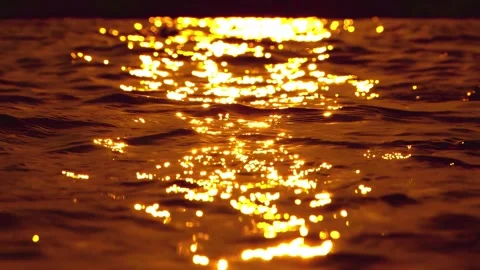 Golden sun glints on water surface with liquid gold of ocean waves. Stock Footage 336629153