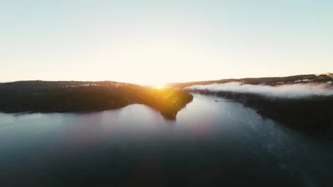 Golden sun glows low over calm waters at Castelo de Bode Stock Footage 342264388
