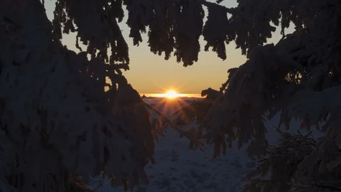 Golden sun going down the mountain tops in scenic winter sunset Stock Footage 124225826