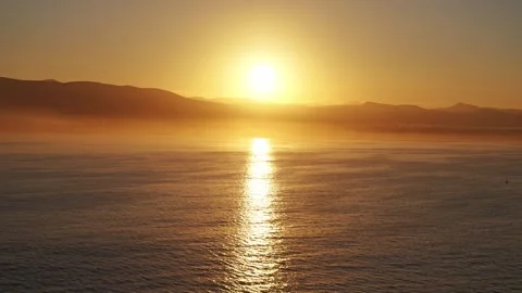 Golden sun path reflecting on calm ocean water at sunset copy space Видео 336661114