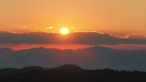 Golden Sun Peaking Through Clouds over Mountains. Video stock 328770414