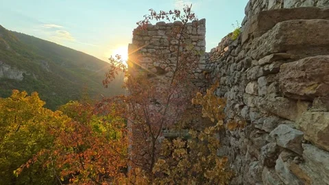 Golden sun peeks through ancient stone ruins. Soko Grad, Serbia 動画素材 345896282