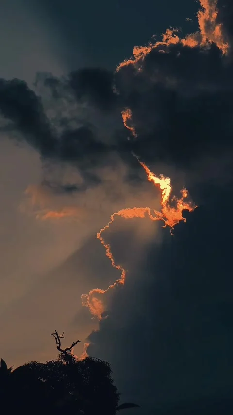Golden Sun Ray Bordering Dark Storm Clouds at Sunset Stock Footage 341267649