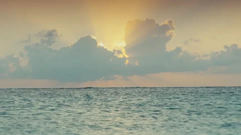 Golden Sun Rays Breaking Through Dramatic Clouds Over Open Calm Ocean Horizon Stock Footage 344139463