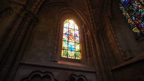 Golden sun rays through stained glass in a church - moody feeling Stock Footage 79923199