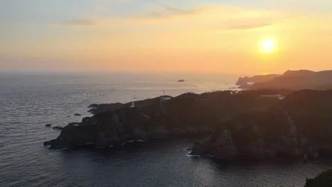 Golden Sun Reflecting on Ocean Surface at Irozaki│4K Drone Aerial Stock Footage 326082049