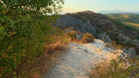 Golden sun sets over rugged hilltops. Soko Grad, Serbia 動画素材 345896578