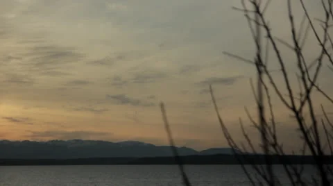 Golden Sun Setting on Mountain Range Camera Pans Left Video stock 25135880