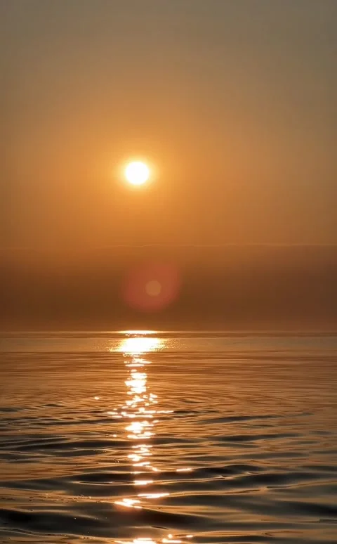 Golden sun setting over calm sea with glittering sun path Stock Footage 346593379