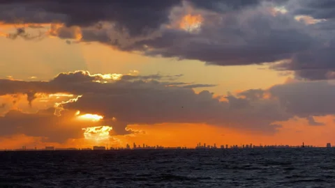 Golden sun setting over ocean with city skyline Copenhagen Stock Footage 324598691