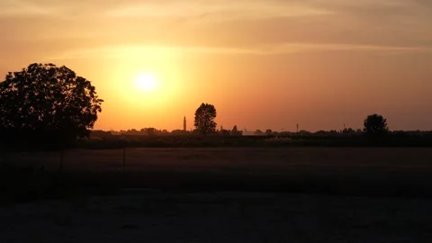 Golden sun setting over a rural landscape Stock Footage 345828171