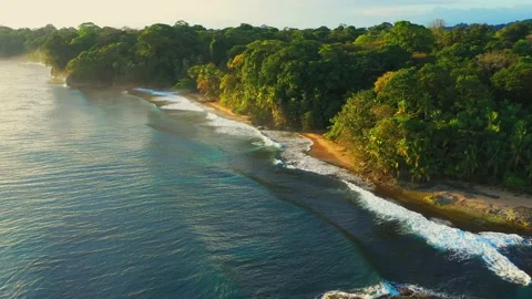 Golden sundown at ocean waves with cliff sand beach and tropics of costa rica Stock Footage 148673190