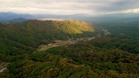 Golden Sunlight Breaking Through Clouds Over Mountains Stock Footage 336624271
