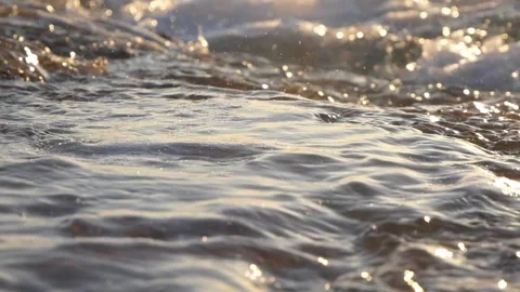 Golden sunlight glitters across the smooth surface of moving water Stock Footage 337414891