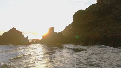 Golden sunlight illuminating the rugged cliffs of la palma's coastline, as the Stock Footage 308418801