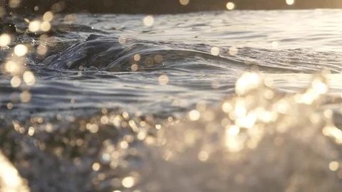 Golden Sunlight On Ocean Waves With Sparkling Bokeh Reflections At Shoreline Stock Footage 337307513