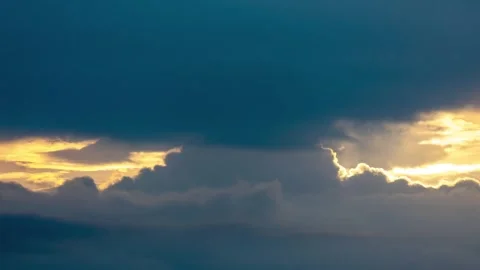 Golden Sunlight Piercing Through Dark Storm Clouds During A Dramatic Sunset Sky Stock Footage 342327734