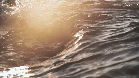 Golden sunlight shines brightly over sparkling ocean waves in motion Stock Footage 337416629
