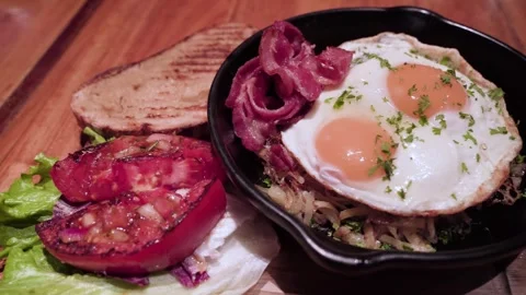 Golden Sunny-Side Up Eggs Over Rice With Bacon, Tomato And Toast. 動画素材 325660733