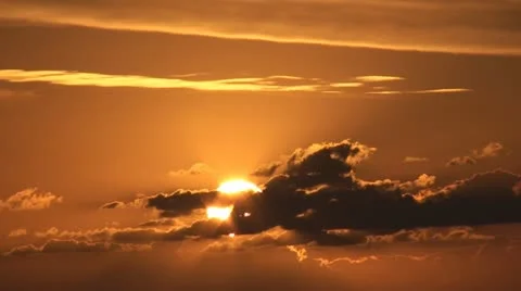 Golden sunrise behind clouds Stock Footage 12678149