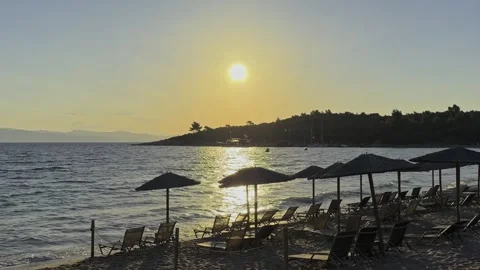 Golden Sunrise Over Empty Beach Loungers And Umbrellas In Chalkidiki Greece 库存影片 345242508