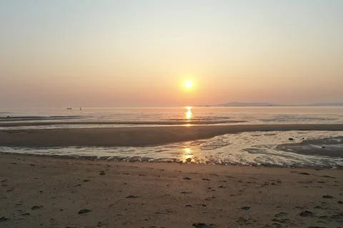 Golden Sunset Beach Landscape with Tranquil Waters and Evening Glow Stock Photos