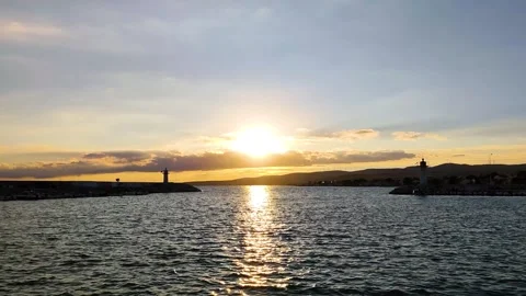 Golden Sunset Between Two Lighthouses on a Marina Entrance Stock Footage 322823179