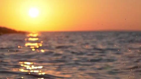Golden sunset casting bright shimmering light over calm ocean waves. Stock Footage 337405899