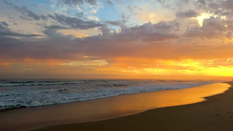 Golden sunset casts a warm glow over the beach  Video stock 291346543