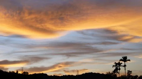 Golden Sunset Clouds in Dramatic Evening Sky Stock Photos