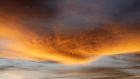 Golden Sunset Clouds in Dramatic Evening Sky Stock Photos