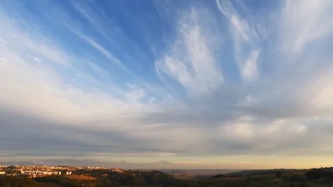 Golden sunset clouds moving fast over a distant city Stock-Footage 342623599