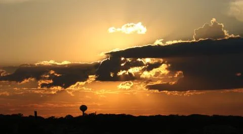 Golden sunset with clouds Stock Photos