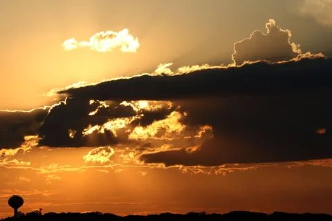 Golden sunset with clouds Stock Photos