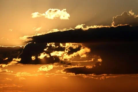 Golden sunset with clouds Stock Photos