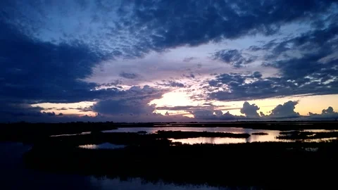 Golden sunset cloudy sky reflections lagoons lakes. timelapse Stock Footage 168522998