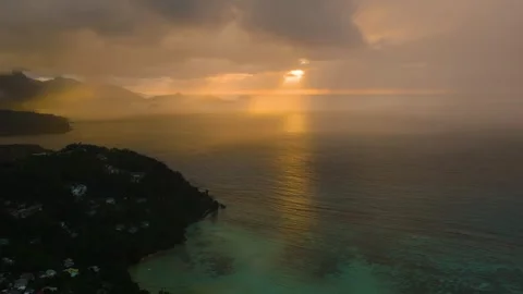 Golden sunset with dark clouds over tranquil ocean. Seychelles, Mahe. Stock Footage 305850740