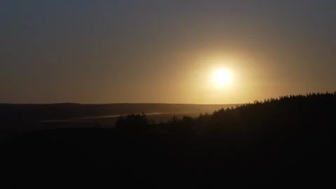 Golden Sunset Light Fading Over a Quiet Wilderness Forest Horizon at Dusk Stock Footage 344877450