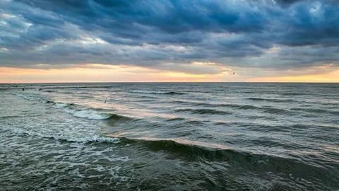 Golden sunset light illuminating dramatic sea waves in Poland. Stock Photos