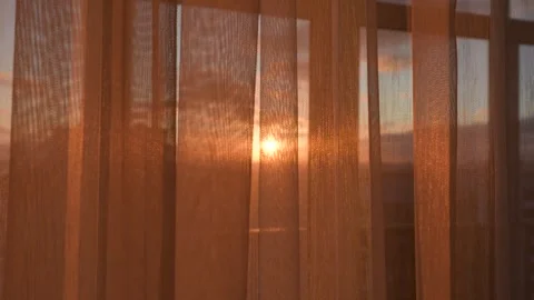 Golden sunset light shining through sheer curtains Stock Footage 324911900