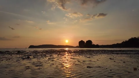Golden sunset with limestone mountains and calm ocean waves. Stock Footage 334568502