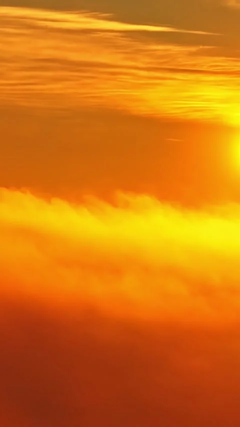 Golden sunset orange clouds high altitude sky aerial view of sun glow dramatic Stock Footage 336238140