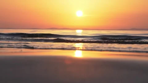 Golden Sunset Over Calm Beach With Ocean Waves and Mirror-Like Reflection Stock Footage 337419482
